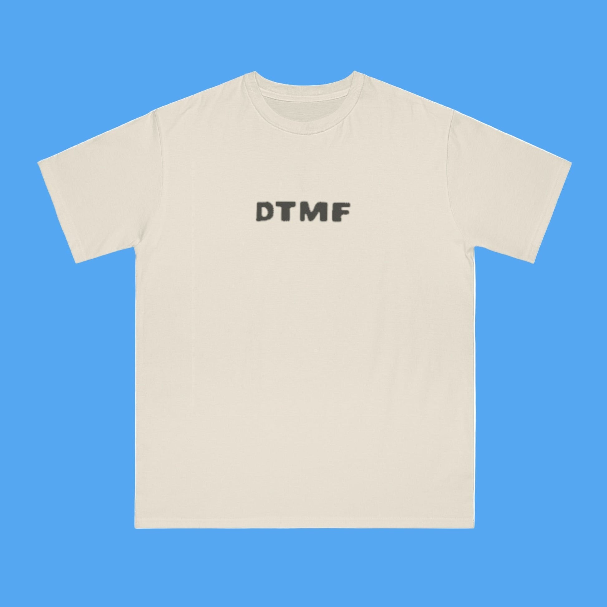 Beige t-shirt with 'DTMF' text on a white background