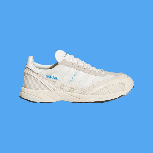 White Adidas sneaker on a light gray background